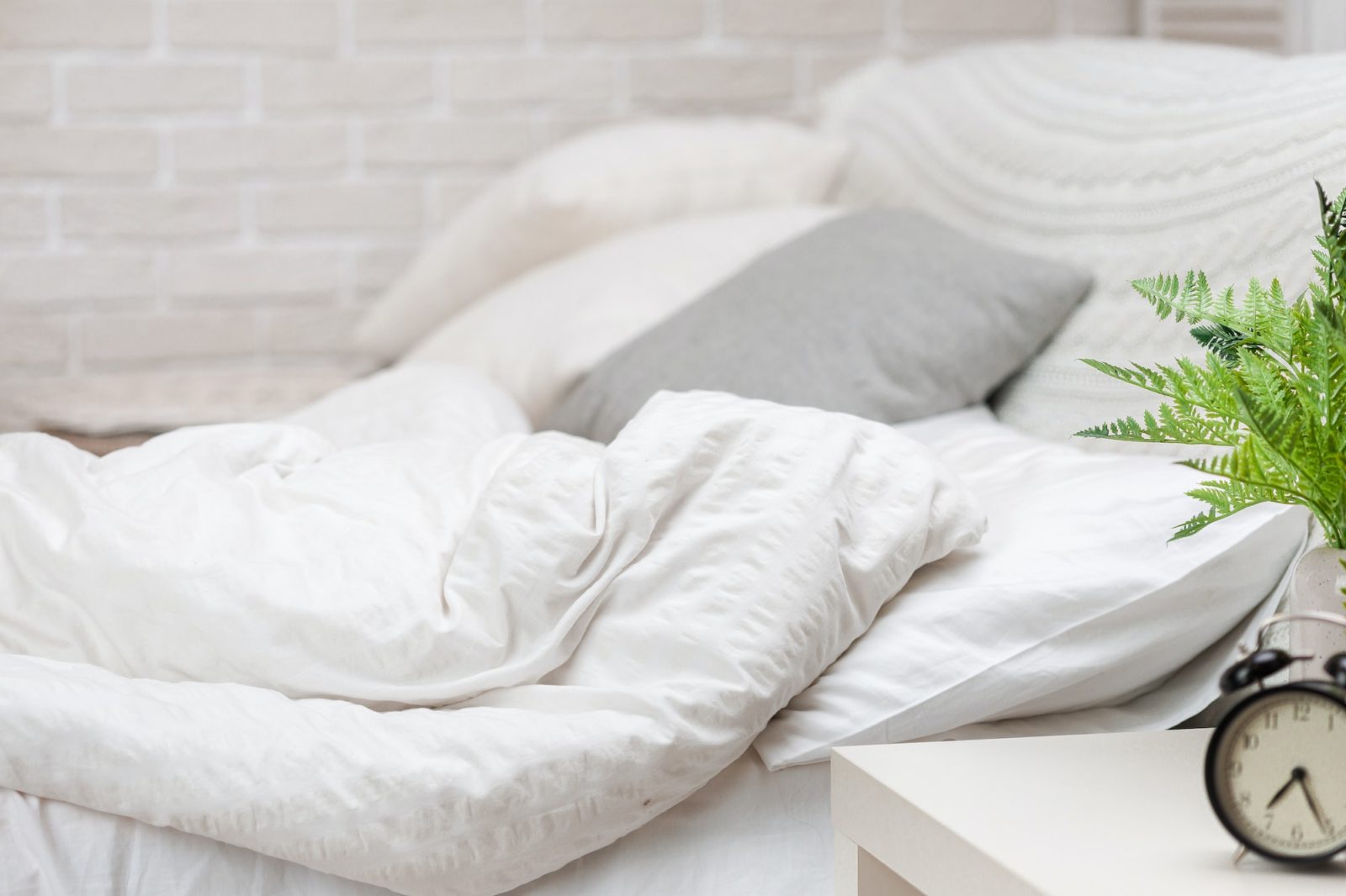 pillows and bed sheets in room.